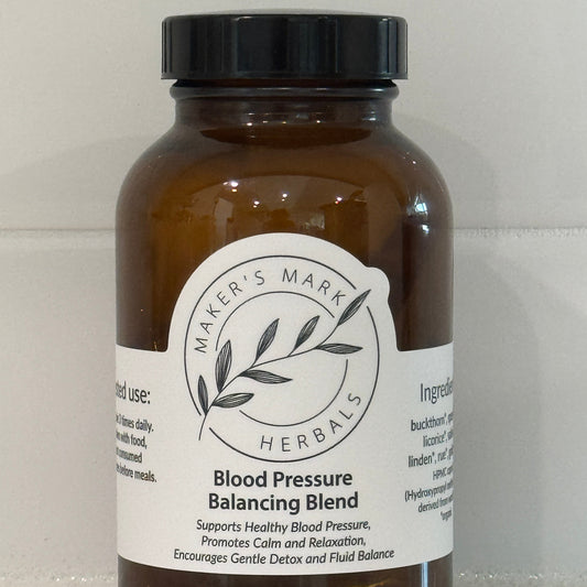 Amber glass bottle with a label for Blood Pressure Balancing Blend on a light gray background